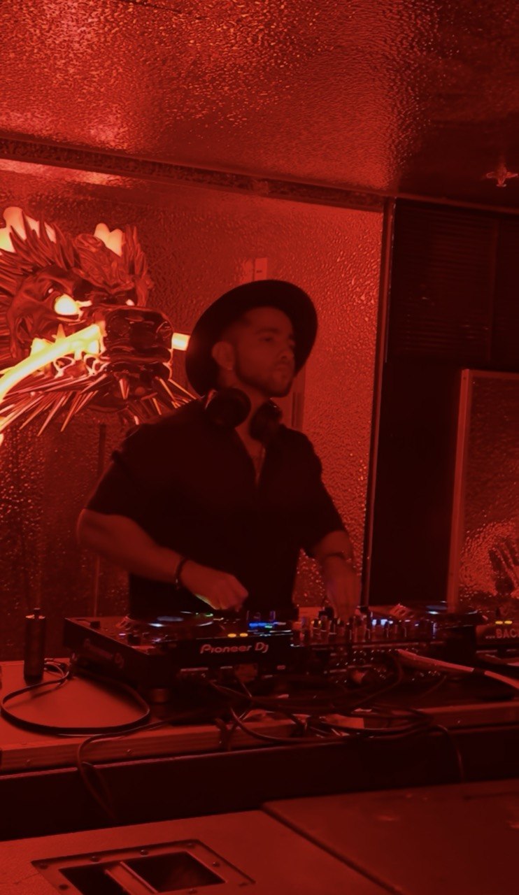FARZY in a red-lit room working the mixer
