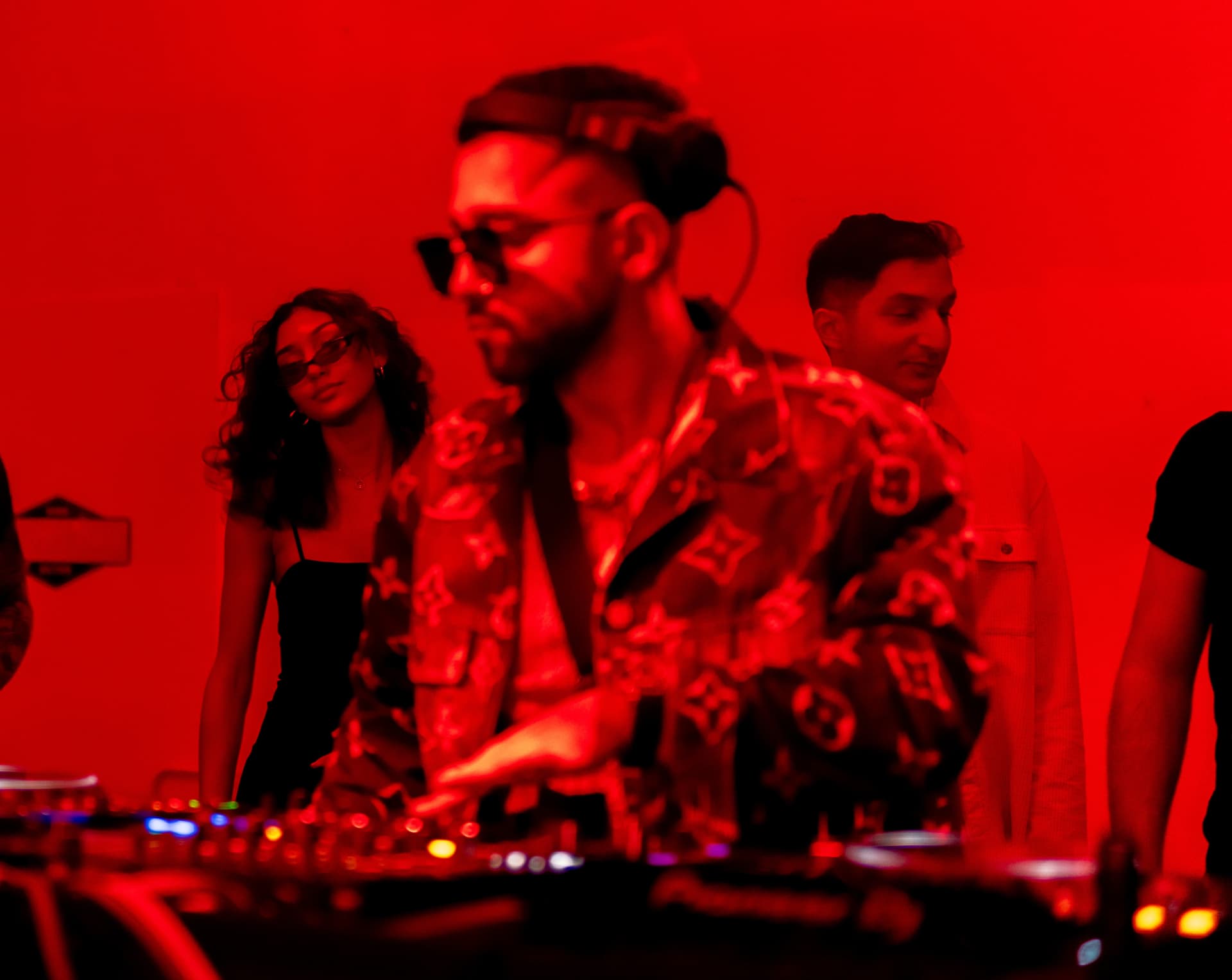 FARZY in deep red light with the crowd close behind