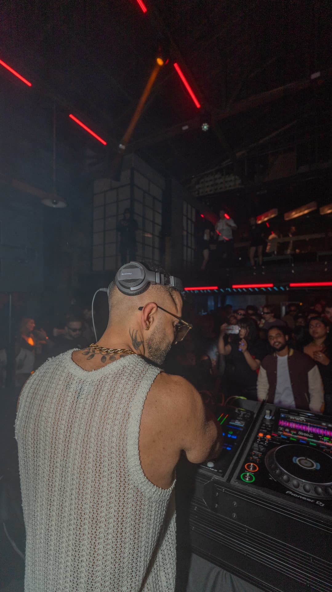 FARZY behind the decks facing a packed warehouse
