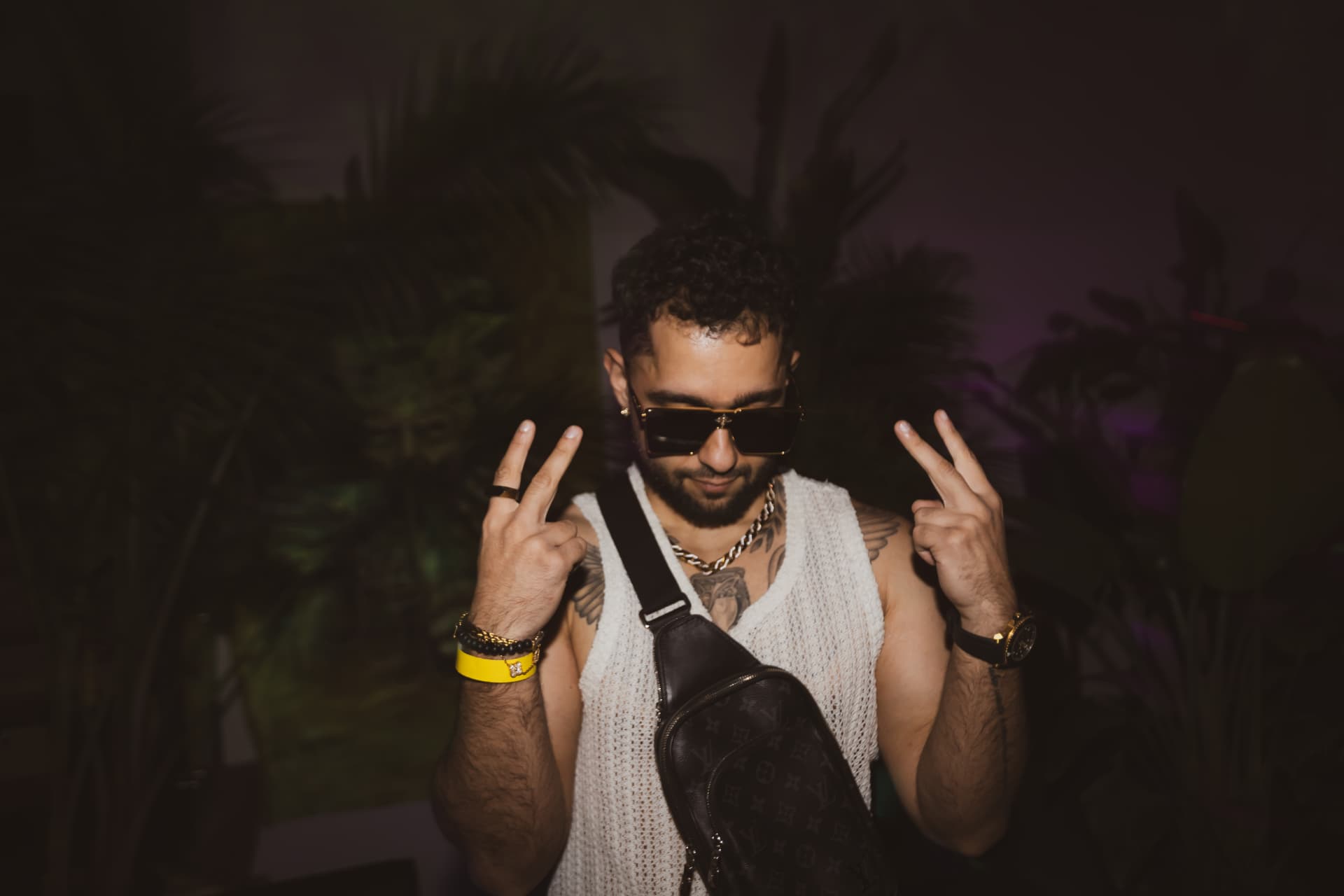 FARZY throwing peace signs in front of the jungle set
